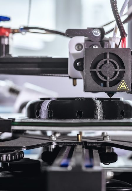 The 3D printer prints black plastic model